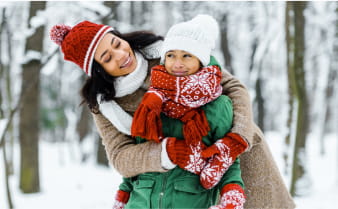 Mom and child play in the snow