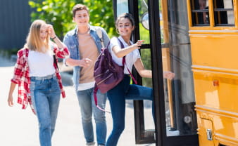 Kids getting on a school bus