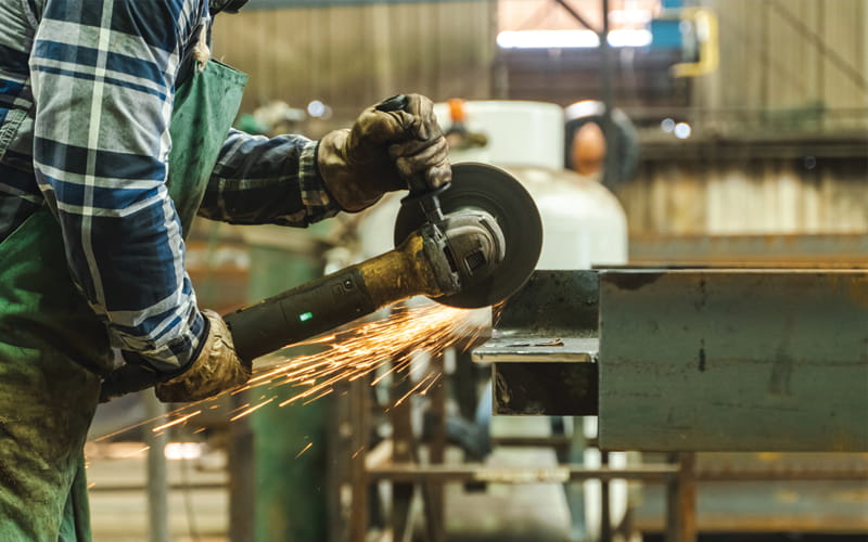 Ennis Steel worker weilding in Dallas, TX warehouse. BOK Financial is proud to partner with Ennis Steel.