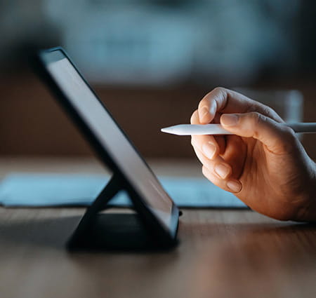 Person checking off items on a tablet computer