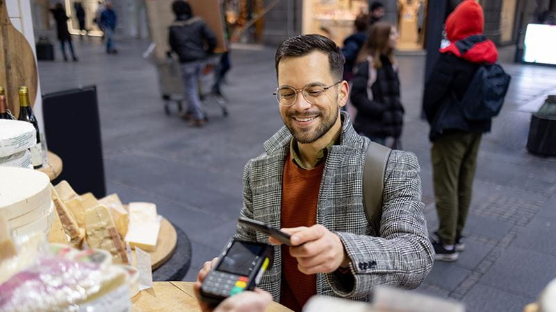 Shopper using a credit card to make a purchase