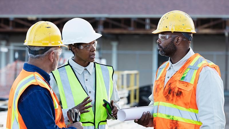 Construction workers discussing Fed rate cut